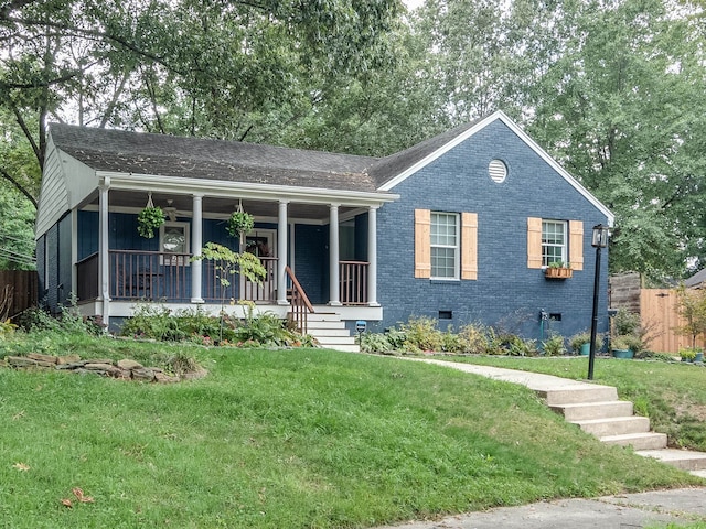 view of front of home with covered porch and a front yard