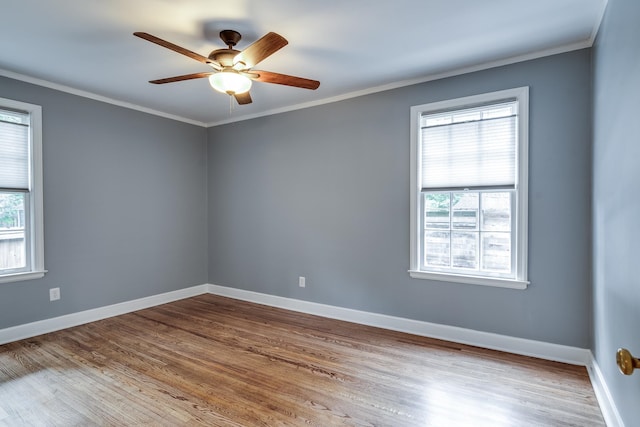 unfurnished room featuring ceiling fan, hardwood / wood-style flooring, and a healthy amount of sunlight