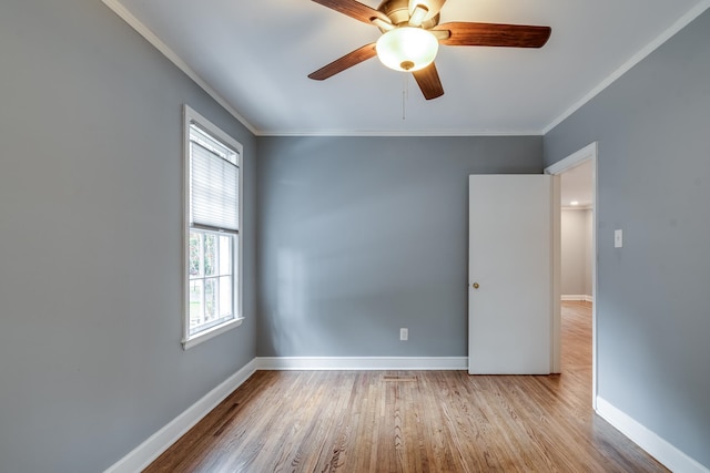 empty room featuring ceiling fan, light hardwood / wood-style flooring, and ornamental molding