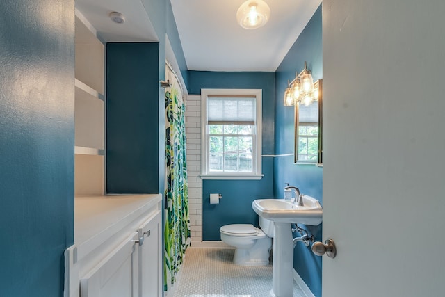 bathroom with tile patterned flooring, a shower with curtain, and toilet