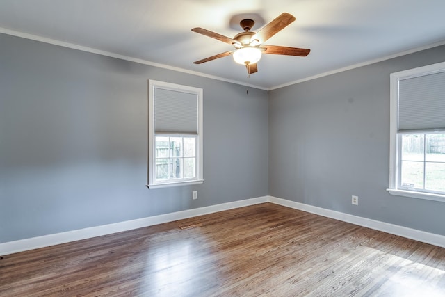 spare room with ceiling fan, hardwood / wood-style floors, and crown molding