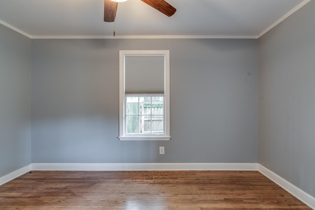 empty room with wood-type flooring, crown molding, and ceiling fan