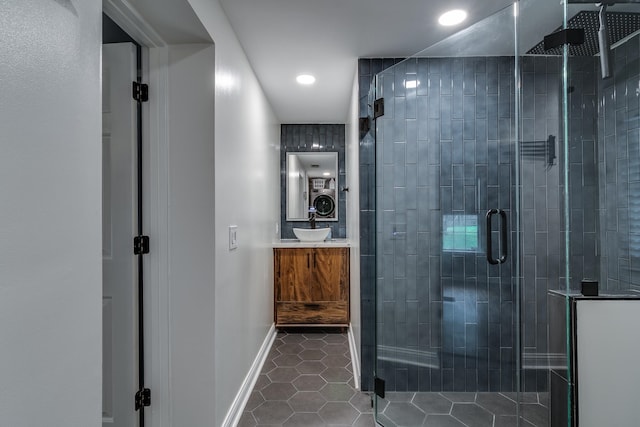 bathroom featuring tile patterned floors, walk in shower, and vanity