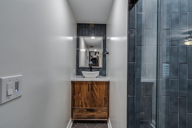 bathroom with vanity, tile patterned flooring, and an enclosed shower