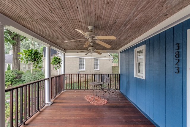 deck with ceiling fan and covered porch