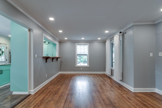 spare room featuring dark hardwood / wood-style floors and ornamental molding