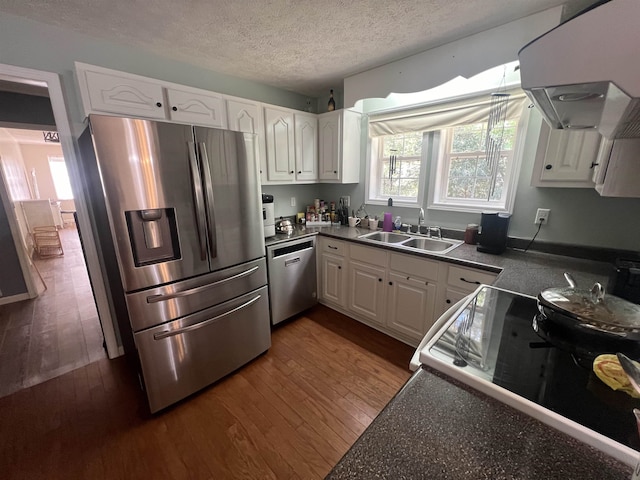 kitchen featuring stainless steel appliances, white cabinets, dark hardwood / wood-style floors, and sink