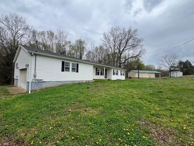 1405 Hurricane Dr, Sardis, TN 38371 - rear view of house with a lawn and a garage
