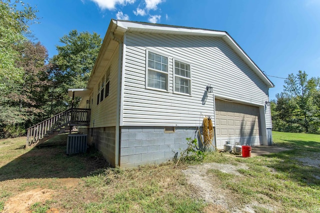 view of home's exterior with central AC unit and a lawn