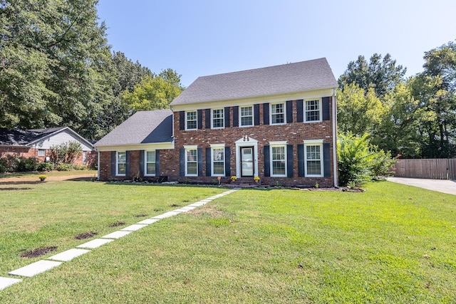 colonial-style house with a front yard