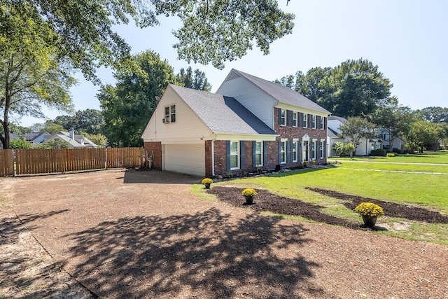 view of side of home with a lawn and a garage