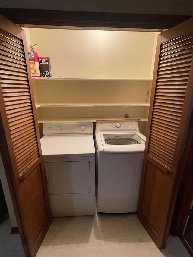 clothes washing area with washer and dryer