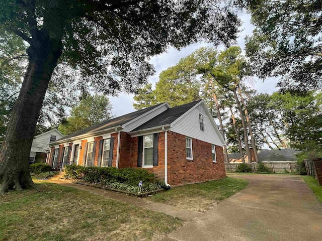 view of property exterior with a lawn