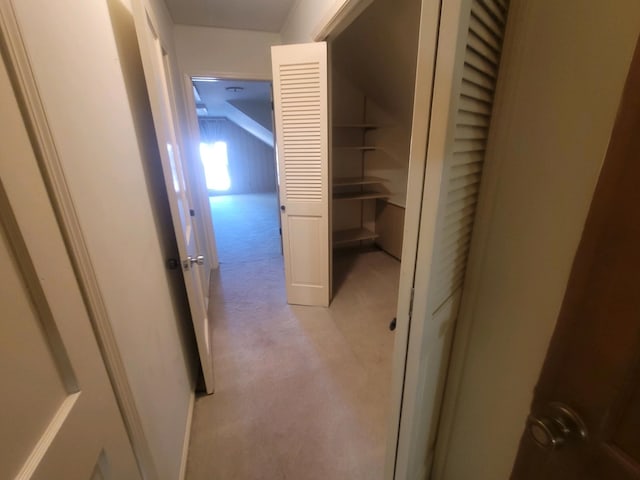 hallway featuring light colored carpet