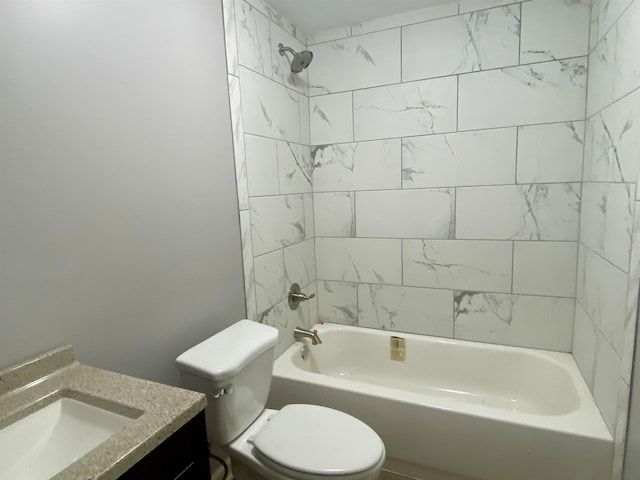 full bathroom featuring tiled shower / bath combo, vanity, and toilet