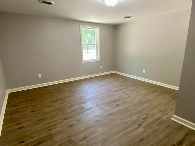 empty room with dark hardwood / wood-style floors