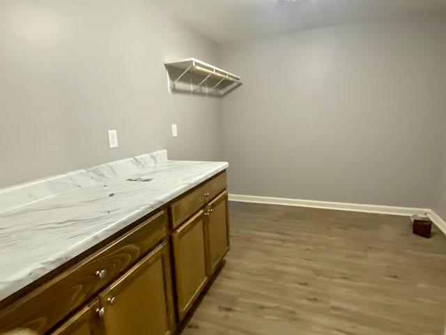 laundry area with hardwood / wood-style floors