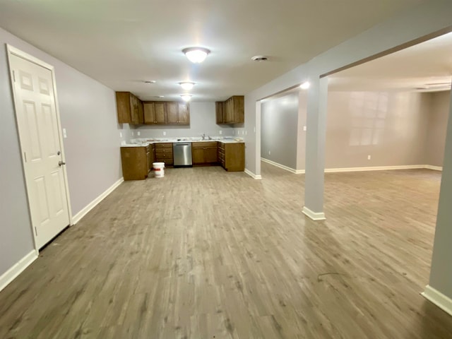 kitchen with dishwasher, light hardwood / wood-style flooring, and sink