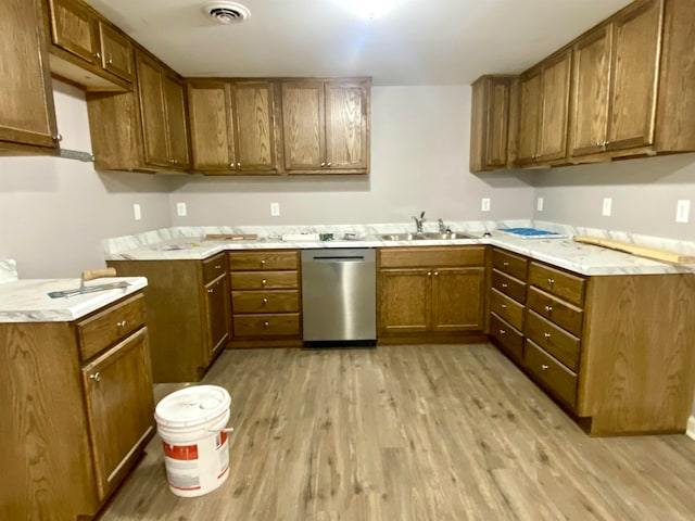 kitchen featuring light hardwood / wood-style flooring, dishwasher, kitchen peninsula, and sink