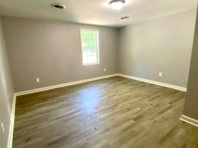 unfurnished room with dark hardwood / wood-style floors