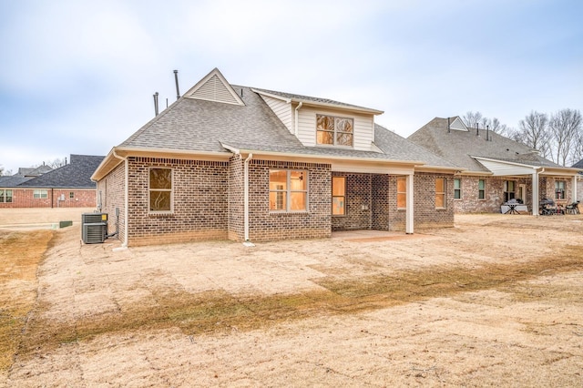 rear view of property featuring central AC unit and a patio area