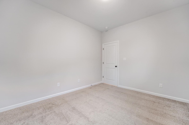 spare room featuring light colored carpet