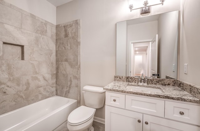 full bathroom featuring tiled shower / bath combo, vanity, and toilet