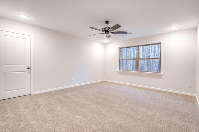 carpeted spare room with ceiling fan