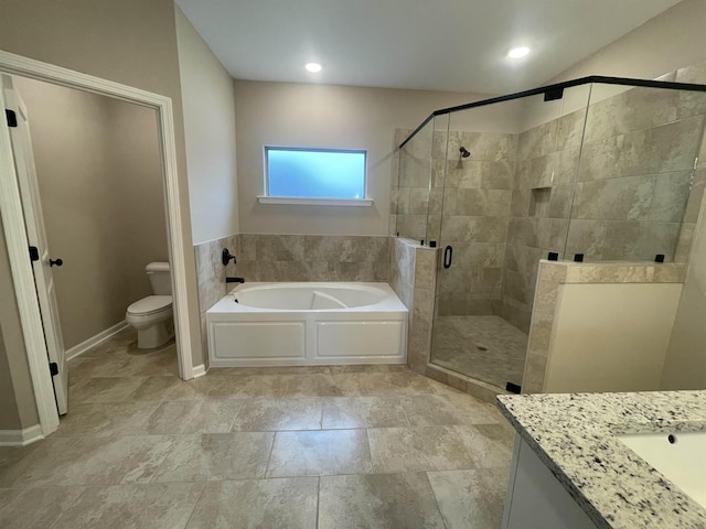 full bathroom with a stall shower, a garden tub, vanity, and toilet