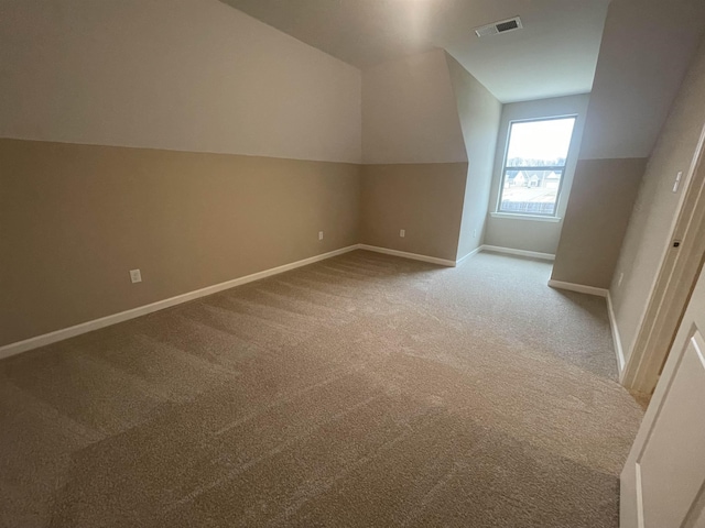 bonus room featuring vaulted ceiling, carpet, visible vents, and baseboards