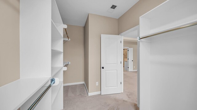 spacious closet with light carpet and visible vents