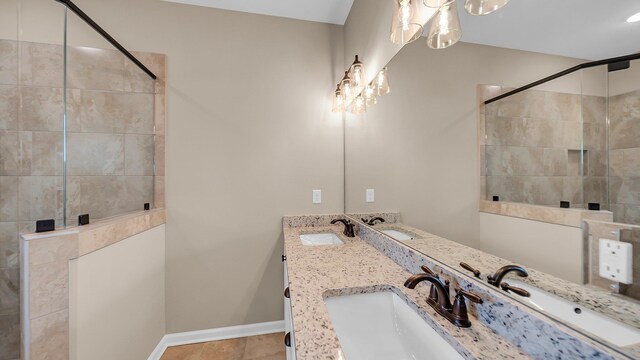 bathroom with a sink, baseboards, and double vanity