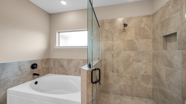 full bathroom with a stall shower and a garden tub