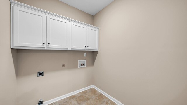 washroom with cabinet space, baseboards, hookup for a gas dryer, hookup for a washing machine, and electric dryer hookup