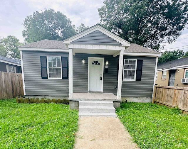 bungalow-style home with a front lawn