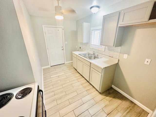 kitchen with ceiling fan, sink, tasteful backsplash, light hardwood / wood-style flooring, and electric stove