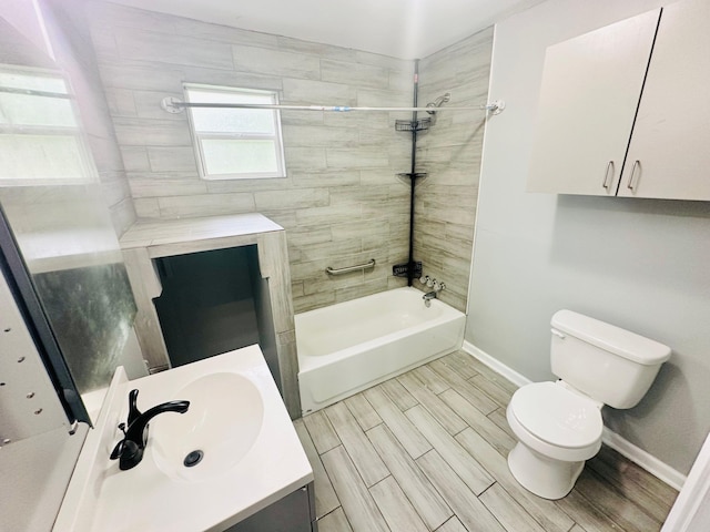 full bathroom with vanity, tiled shower / bath, and toilet