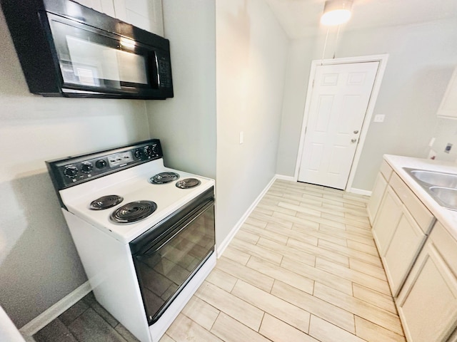 kitchen with electric stove and sink