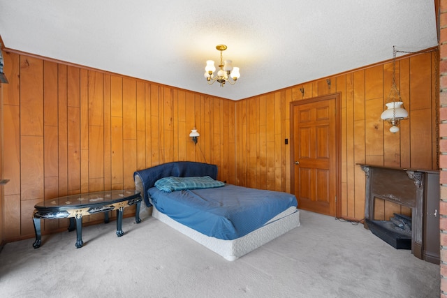 bedroom featuring a notable chandelier, wood walls, a textured ceiling, and light carpet