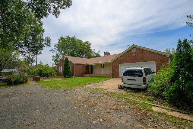 single story home with a front lawn and a garage