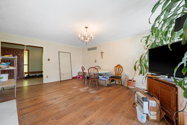 interior space featuring wood-type flooring and a notable chandelier