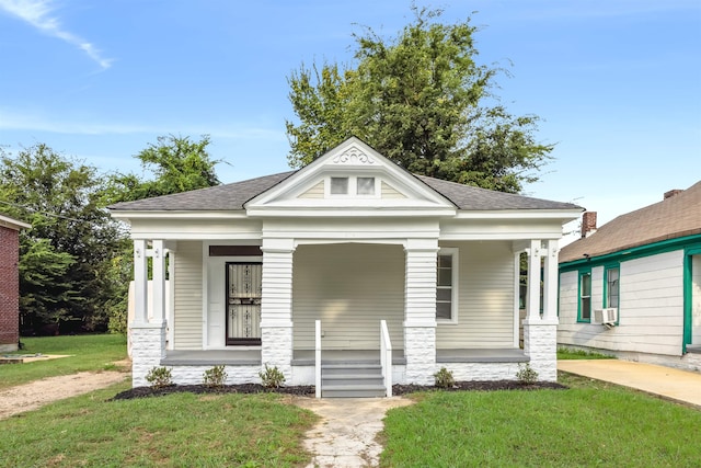 greek revival house with cooling unit, a front lawn, and covered porch