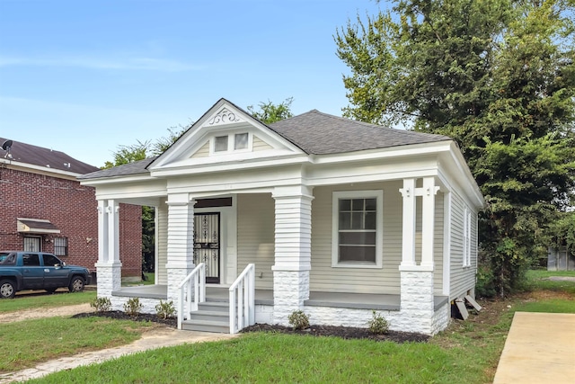 greek revival house featuring a front lawn and a porch