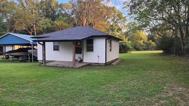 view of outbuilding featuring a lawn