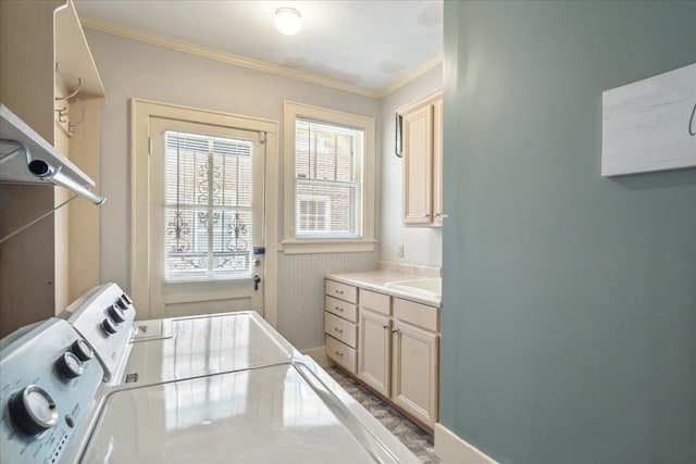 laundry area featuring ornamental molding and washer and dryer