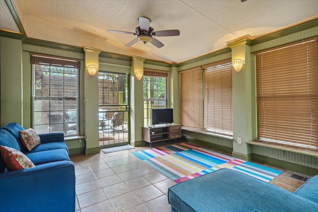 tiled living room featuring ceiling fan, lofted ceiling, and crown molding