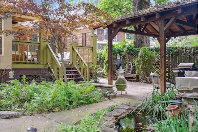 surrounding community with a gazebo, a wooden deck, and a patio area