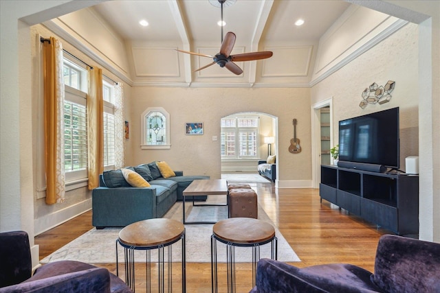 living room with light wood-type flooring, lofted ceiling with beams, and ceiling fan