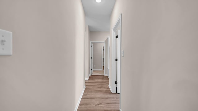 hallway with light hardwood / wood-style flooring