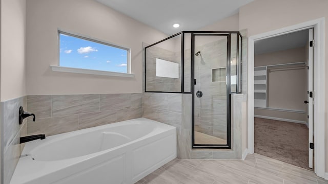 bathroom featuring plus walk in shower